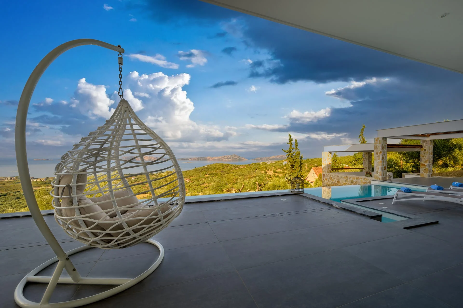 Κρεμαστη πολυθρονα στη βεραντα της Koa Spa Βιλα διπλα στην πισινα